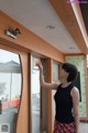 A woman standing in front of a glass door pointing at something.