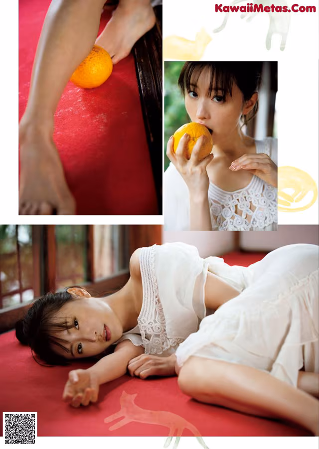 A woman laying on a red couch eating an orange.