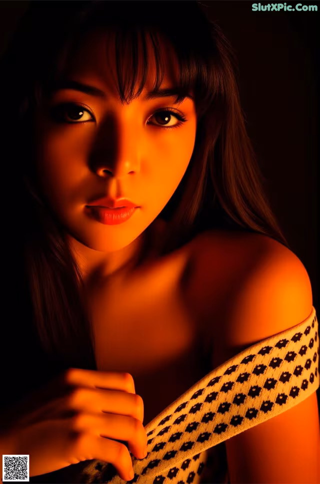 A woman with long brown hair is posing for a picture.