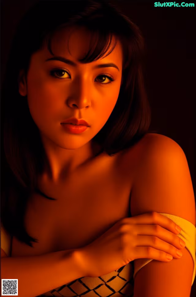 A woman in a yellow dress is posing for a picture.