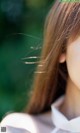 A close up of a woman's face with long hair.